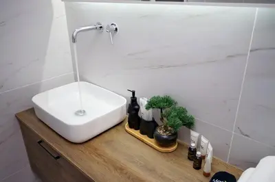 a bathroom with a sink and a mirror and a sink at Two Bedroom Flat In Athens in Athens