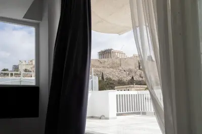 a window with a view of a building at Wake Up to the Acropolis in a Hidden Gem in Athens