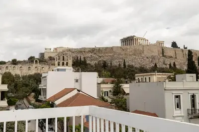 a view of the acropolis from the balcony of a building at Wake Up to the Acropolis in a Hidden Gem in Athens