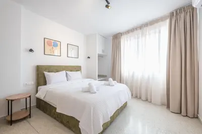 a bedroom with a large bed and a large window at Spacious Couples Studio with Seating Area & Rooftop Vibes Zen Gaia By Tessera in Athens