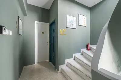 a hallway with stairs and a blue door at Spacious Couples Studio with Seating Area & Rooftop Vibes Zen Gaia By Tessera in Athens
