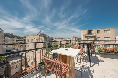 a patio with a table and chairs on a balcony at Spacious Couples Studio with Seating Area & Rooftop Vibes Zen Gaia By Tessera in Athens