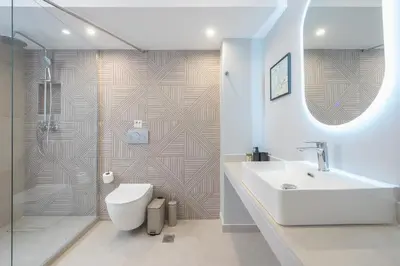 a bathroom with a toilet and a sink and a shower at Spacious Couples Studio with Seating Area & Rooftop Vibes Zen Gaia By Tessera in Athens