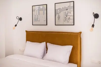 a bedroom with a bed with three pictures on the wall at Penthouse Zen Harmonia By Tessera in Athens