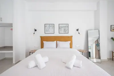 a bedroom with a large white bed with white pillows at Penthouse Zen Harmonia By Tessera in Athens