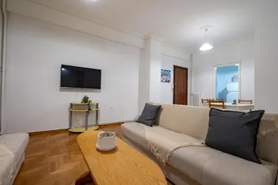 a living room with a couch and a coffee table at Phoebe 3BR apartment in Neos Kosmos by ΜΡS in Athens