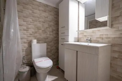 a bathroom with a toilet and a sink and a mirror at Phoebe 3BR apartment in Neos Kosmos by ΜΡS in Athens