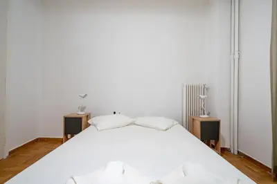 a bedroom with a white bed with two night stands at Phoebe 3BR apartment in Neos Kosmos by ΜΡS in Athens