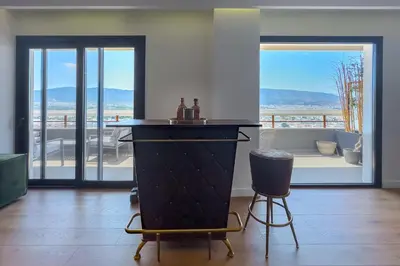 a living room with a couch and a table and chairs at Phaedrus Living Apollo Skyview Penthouse in Athens