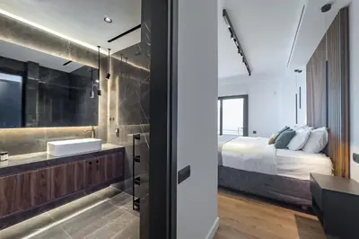 a bathroom with a sink and a bed in a room at Phaedrus Living Apollo Skyview Penthouse in Athens
