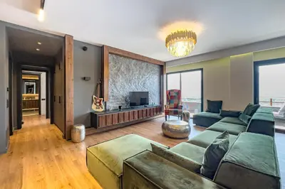a living room with a couch and a television at Phaedrus Living Apollo Skyview Penthouse in Athens