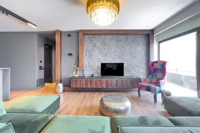 a living room with a couch and a flat screen tv at Phaedrus Living Apollo Skyview Penthouse in Athens