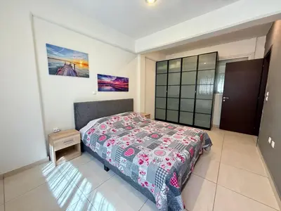 a bedroom with a bed with a colorful bedspread at Alimos Cozy Apartment in Athens