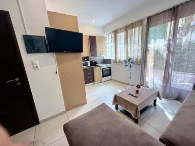 a living room with a couch and a table at Alimos Cozy Apartment in Athens
