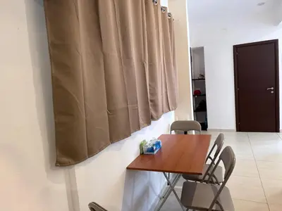 a table and chairs in a room with a curtain at Alimos Cozy Apartment in Athens
