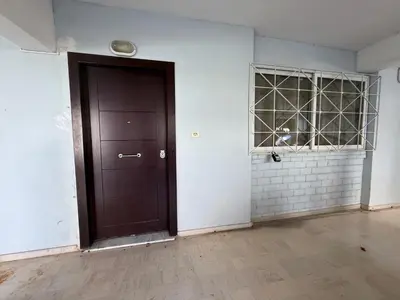 a dark brown door in a room with white walls at Alimos Cozy Apartment in Athens