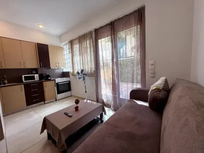 a living room with a couch and a table at Alimos Cozy Apartment in Athens