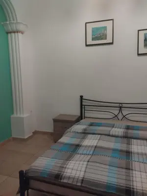 a bedroom with a bed with a plaid blanket at Golden room 1 in Athens