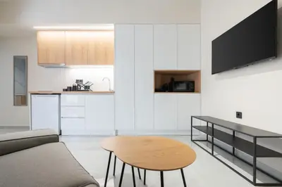 a living room with a couch and a table at LIV - Comfortable Athens Studios in Athens