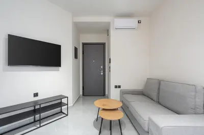a living room with a couch and a table at LIV - Comfortable Athens Studios in Athens