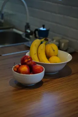 two bowls of fruit on a wooden table at 360 Athens Rooftop Nest, 300m from Metro Station, Acropolis View in Athens