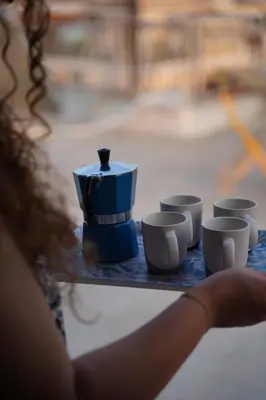 a table with cups and a blue box on it at 360 Athens Rooftop Nest, 300m from Metro Station, Acropolis View in Athens