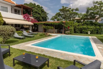 a swimming pool in the backyard of a house at Olive Grove Villa in Koropíon