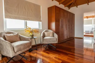two chairs and a table in a living room at Olive Grove Villa in Koropíon