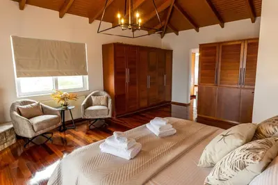 a bedroom with a large bed with towels on it at Olive Grove Villa in Koropíon