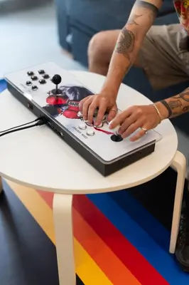 a person typing on a laptop on a table at 2BR Family Apartment With Playroom-Arcade, 2 Bathrooms & 2 Kitchens in Athens