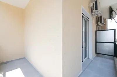 a room with a white wall and a window at 2BR Family Apartment With Playroom-Arcade, 2 Bathrooms & 2 Kitchens in Athens
