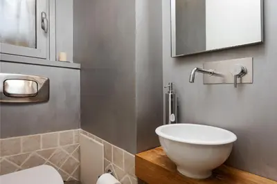 a bathroom with a white bowl sink and a mirror at Vouliagmeni Exclusive Residence in Athens