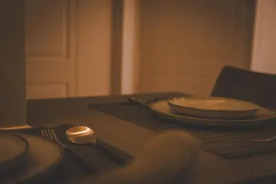a table with two plates and a spoon on it at Aura and Luxury in Athens