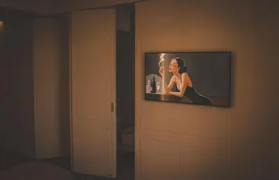 a television on a wall with a picture of a woman at Aura and Luxury in Athens