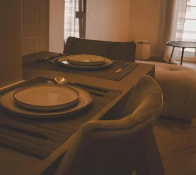 a wooden table with plates and utensils on it at Aura and Luxury in Athens
