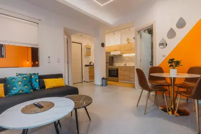 a living room with a couch and a table at Calmio Athens 2 in Athens