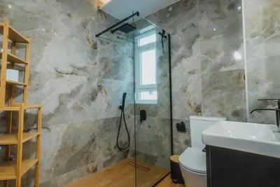 a bathroom with a shower and a toilet and a sink at Calmio Athens 2 in Athens