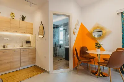 a kitchen and dining room with a table and chairs at Calmio Athens 2 in Athens