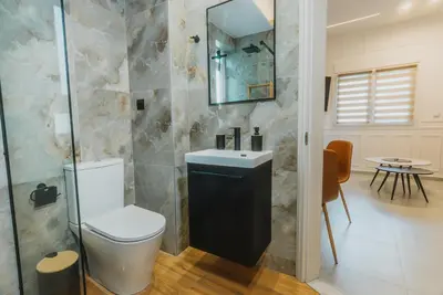 a bathroom with a toilet and a sink at Calmio Athens 2 in Athens