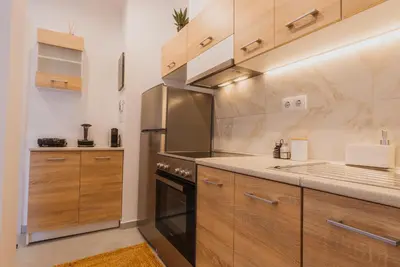 a kitchen with wooden cabinets and a stove at Calmio Athens 2 in Athens