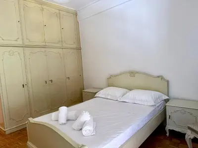 a bedroom with a bed with two towels on it at Neos Kosmos Family Apartment in Athens