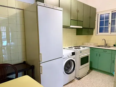 a kitchen with a refrigerator and a washing machine at Neos Kosmos Family Apartment in Athens