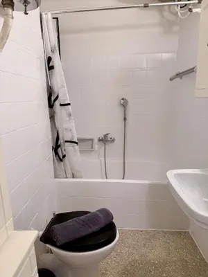 a bathroom with a toilet and a tub and a sink at Neos Kosmos Family Apartment in Athens
