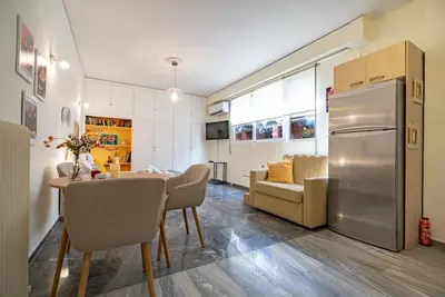 a kitchen and dining room with a table and a refrigerator at Plaka City Studio - Walk to Syntagma by ΜΡS in Athens