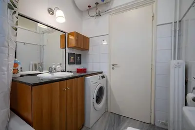 a bathroom with a sink and a washing machine at Plaka City Studio - Walk to Syntagma by ΜΡS in Athens