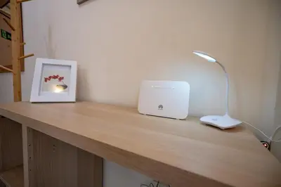 a desk with a laptop computer and a lamp on it at Plaka City Studio - Walk to Syntagma by ΜΡS in Athens