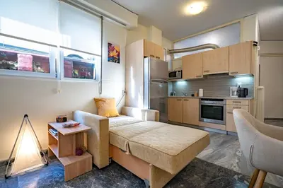 a small living room with a couch and a kitchen at Plaka City Studio - Walk to Syntagma by ΜΡS in Athens