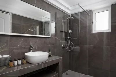 a bathroom with a sink and a mirror at Majestique South Riviera Residence in Athens