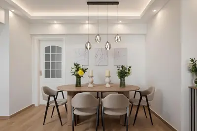 a dining room with a table and chairs at Majestique South Riviera Residence in Athens
