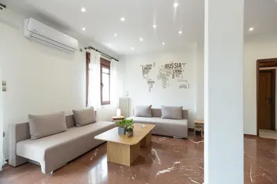 a living room with a couch and a table at Luxury, entire, 2-10 person apartment in ilioupoli in Athens